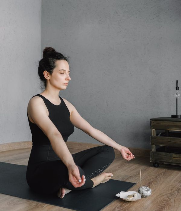 Woman feeling energized and calm in a bright, modern space.